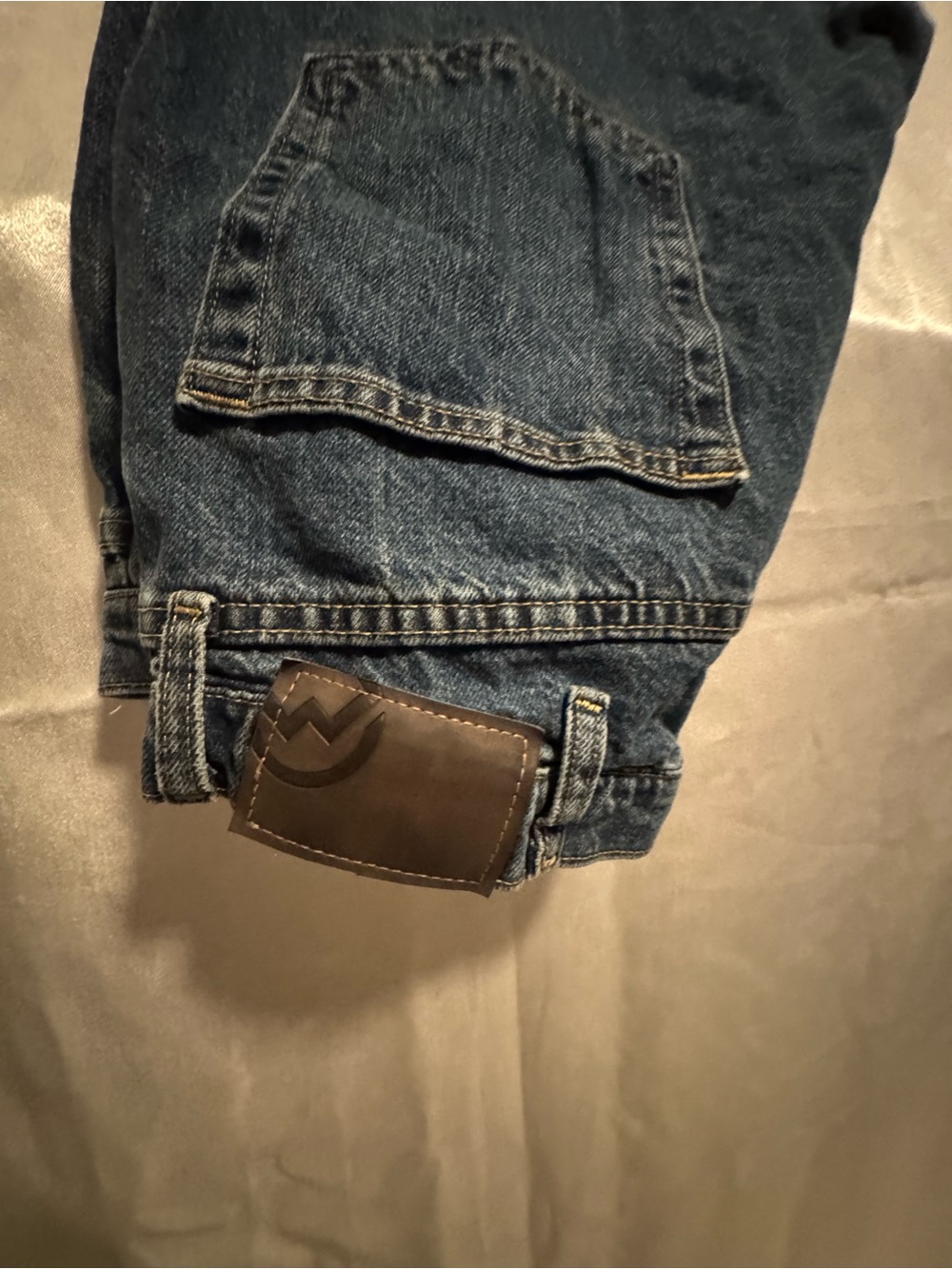 Magellan Outdoors Men’s Relaxed Blue Denim Jeans with Brown Patch